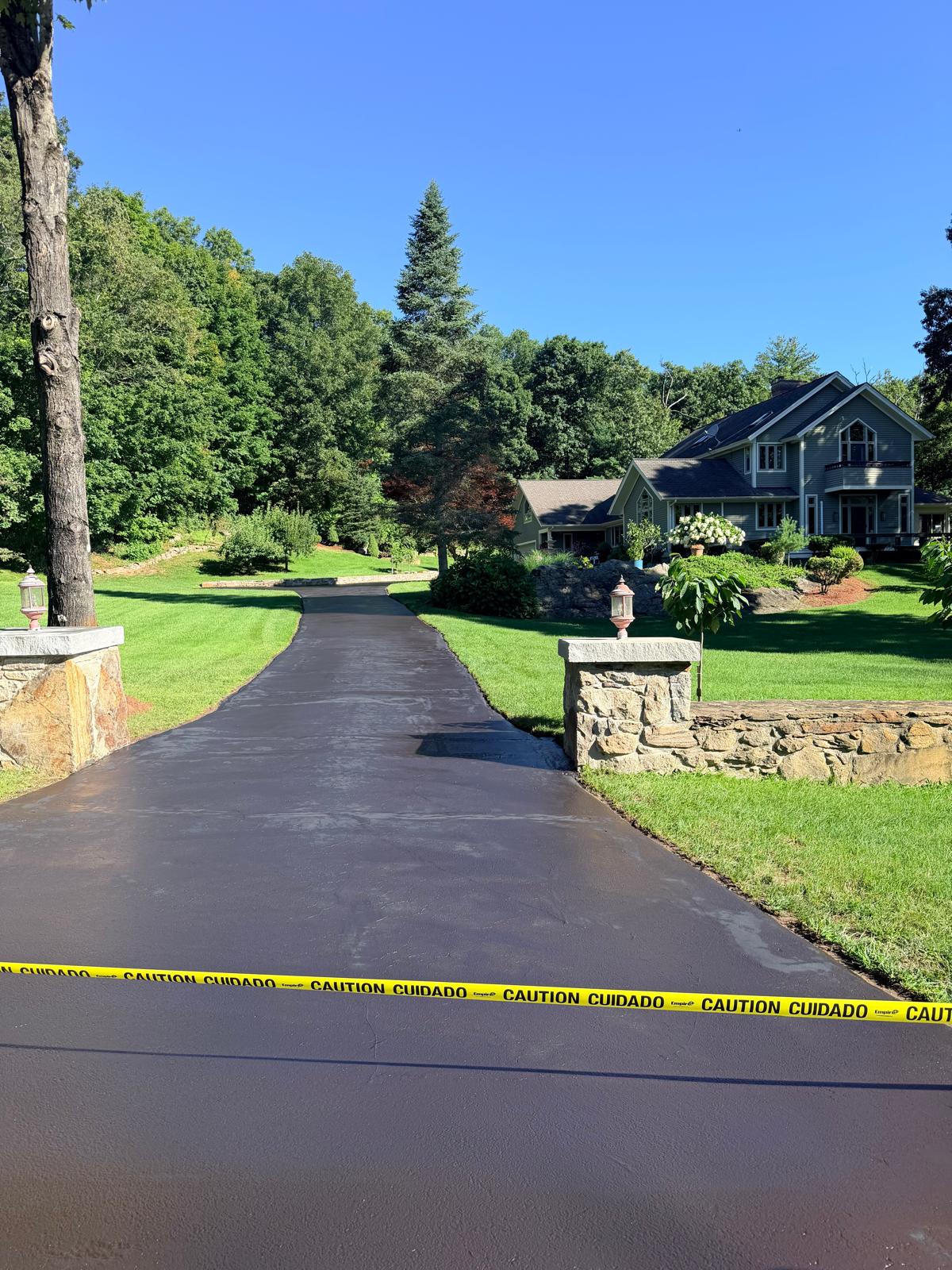 Long residential driveway after professional sealcoating