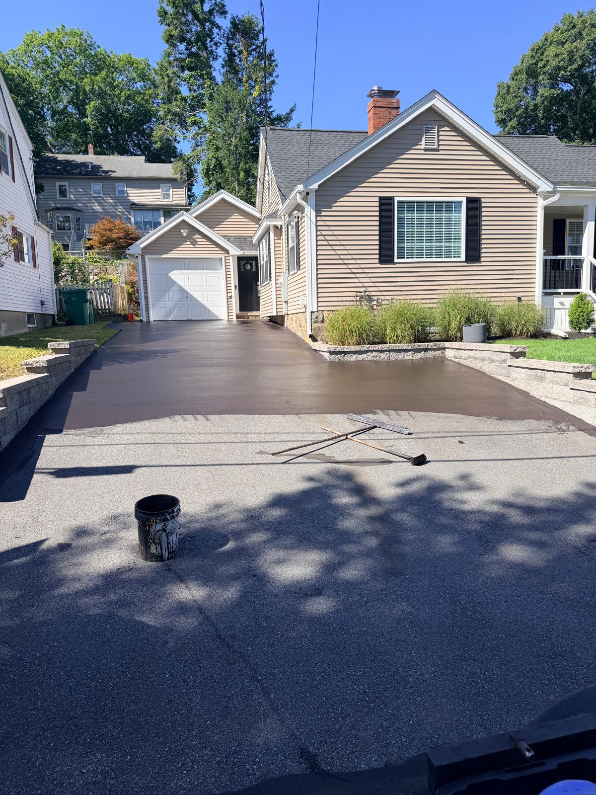 Sealcoat being applied to a residential driveway